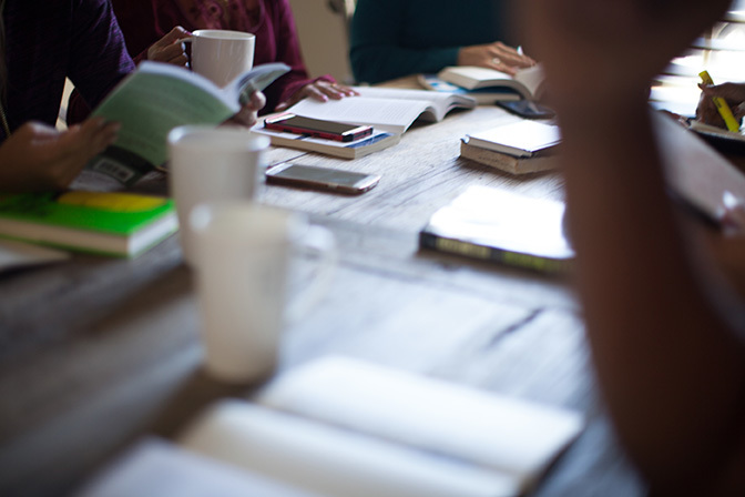 Stock group around table with open bibles