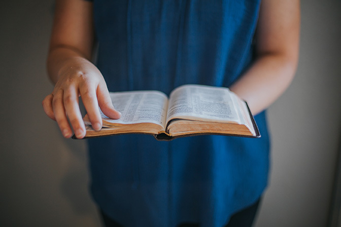 Stock hands holding open bible