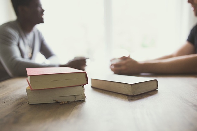 Stock two men talking with bibles